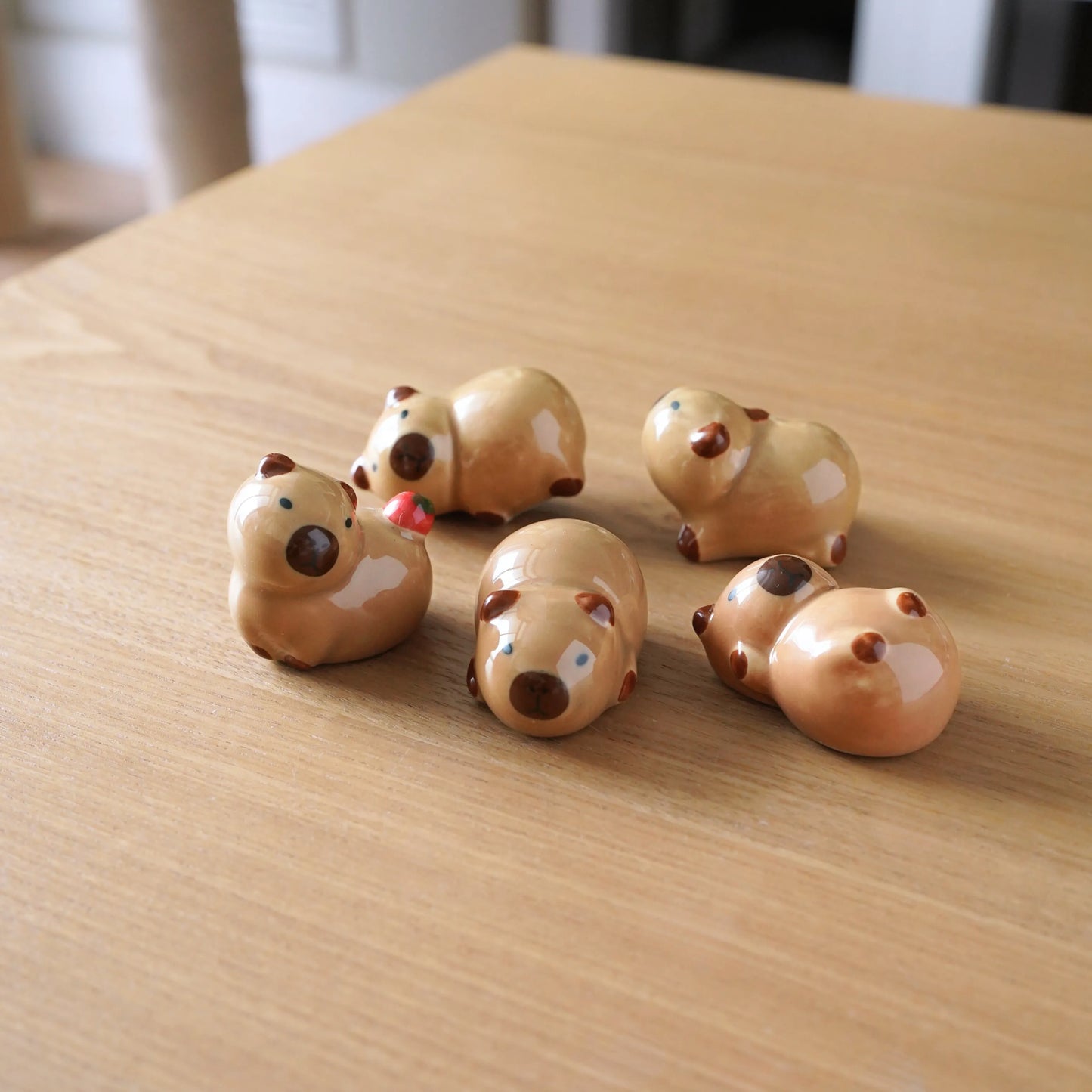 🦫 Capybara-Shaped Ceramic Utensil & Chopstick Rest
Bring a calm, cozy capybara vibe to your dining table or desk! 
Each piece measures approximately 1” x 2” — small, sturdy, and irresistibly cute.

✨ Multi-Purpose Magic:
Not just for chopsticks! These capybara rests are perfect for holding:
🍴 Forks, spoons, and knives
🥢 Chopsticks
🖊 Pens & pencils
🖌 Paintbrushes or makeup brushes