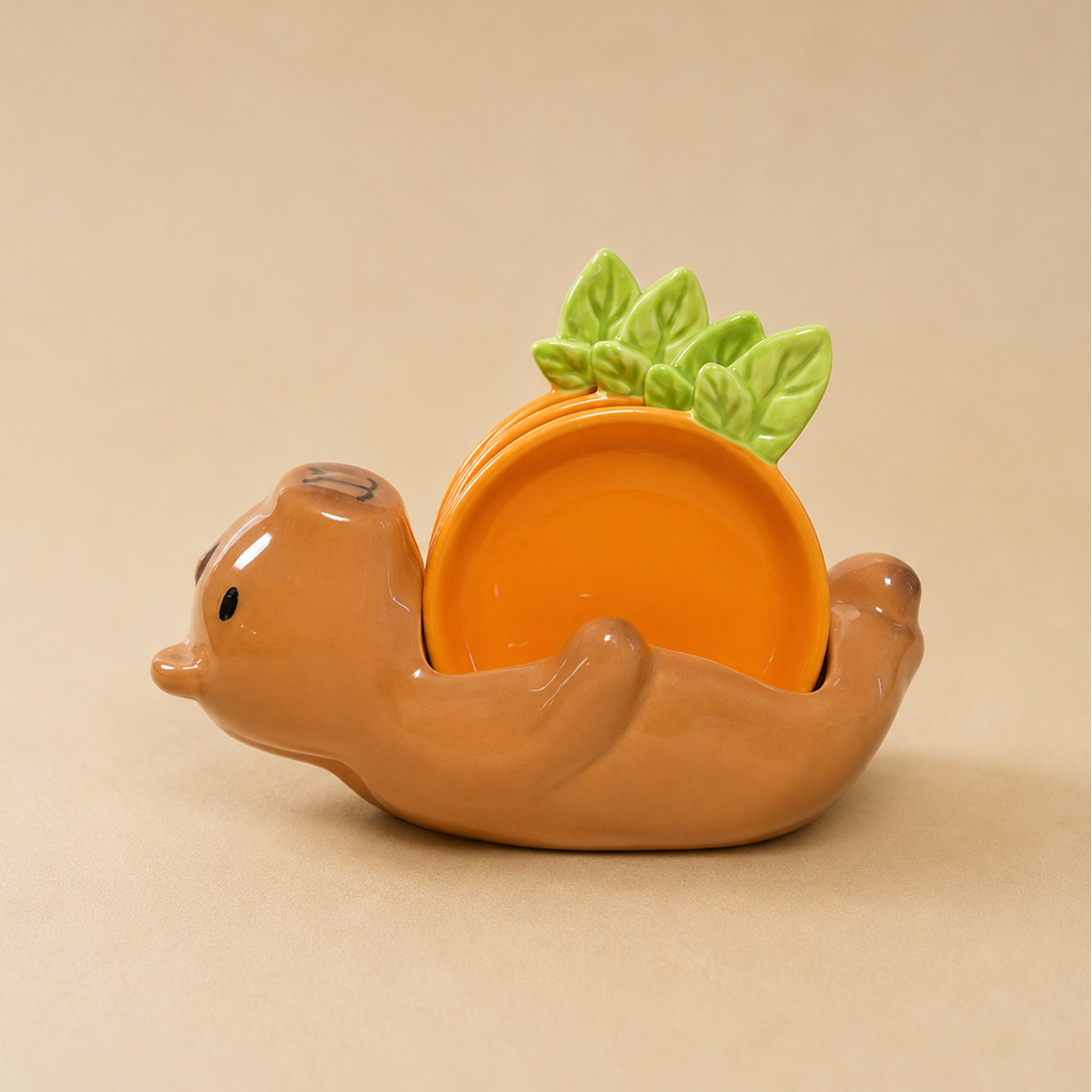 A ceramic capybara-shaped dish holder in warm brown, holding a small orange plate with green leaf accents, set against a solid beige background.