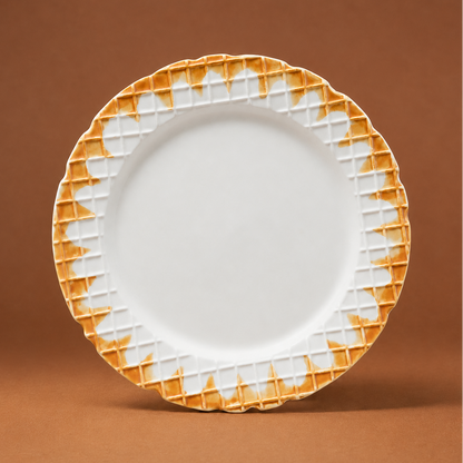 A white ceramic plate with a textured, scalloped orange-gold rim, standing upright against a solid brown background.
