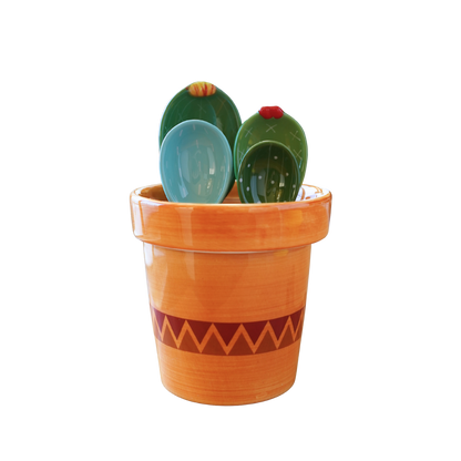 Green and blue cactus measuring spoons with striped terracotta ceramic cup
